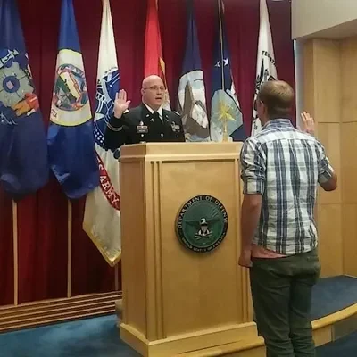 Jay Reeves in Army uniform administering an oath during a military ceremony